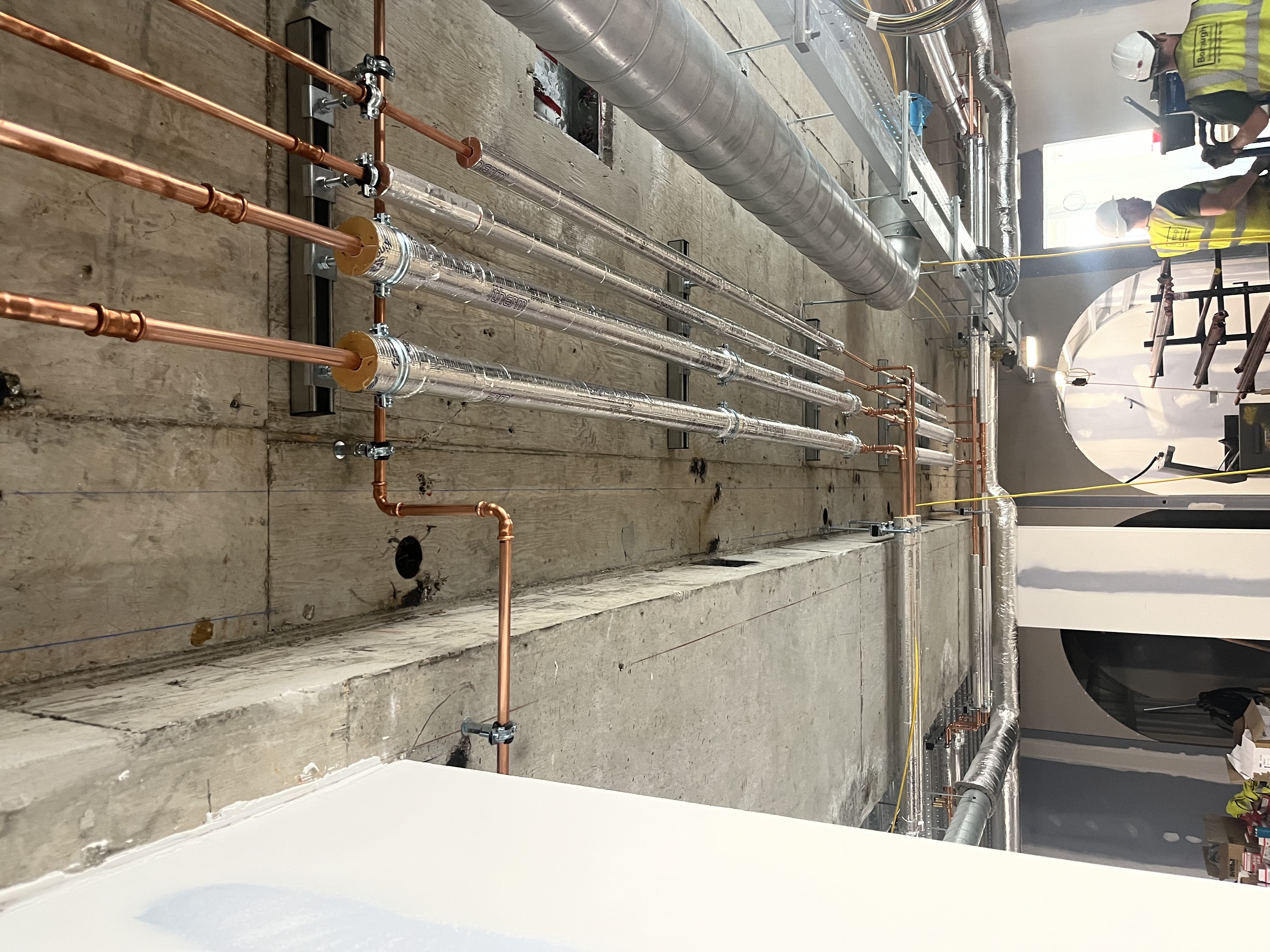 Copper pipework with insulation on concrete ceiling